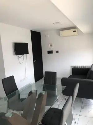 a living room with a glass table and chairs at FOREST 7º in Cordoba