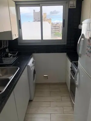 a small kitchen with a sink and a window at FOREST 7º in Cordoba