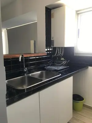a kitchen with a sink and a black counter top at FOREST 7º in Cordoba