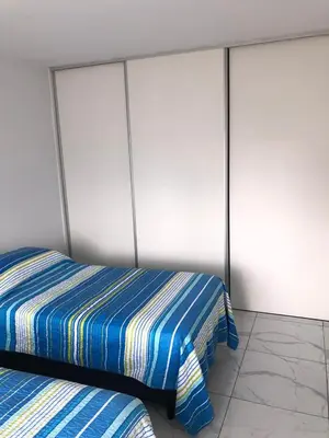 a bedroom with a bed and two closets at FOREST 7º in Cordoba