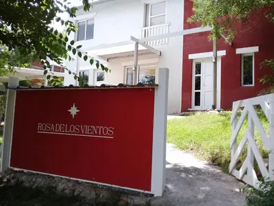 a red sign in front of a building at Rosa de los Vientos in Nono