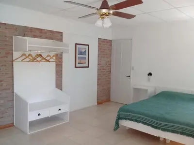 a bedroom with a bed and a ceiling fan at Rosa de los Vientos in Nono