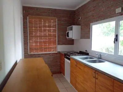 a kitchen with a counter and a sink and a window at Rosa de los Vientos in Nono