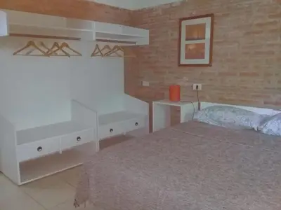 a bedroom with a bed and a white dresser at Rosa de los Vientos in Nono