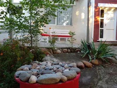 a fire pit with rocks in front of a house at Rosa de los Vientos in Nono