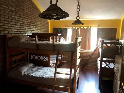 a room with two bunk beds and a brick wall at Terrazas De Potrero in Potrero de Garay