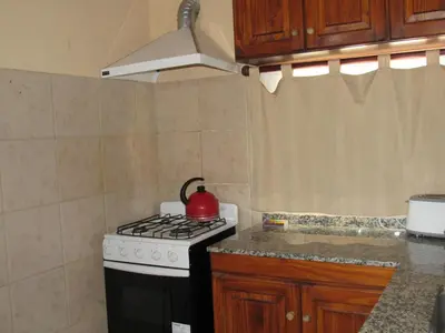 a kitchen with a stove with a tea kettle on it at Terrazas De Potrero in Potrero de Garay