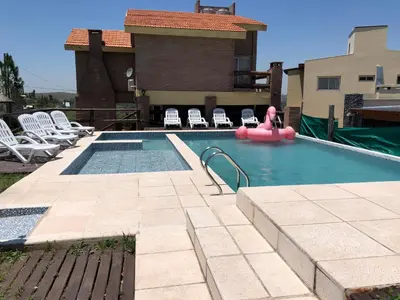 a swimming pool with a pink float in a house at Terrazas De Potrero in Potrero de Garay