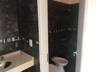 a bathroom with a toilet and a sink at COMPLEJO AYRES DE MAYU SUMAJ in Villa Carlos Paz