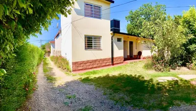 a house with a pathway leading up to it at Aires de las Sierras 2 in Villa Carlos Paz