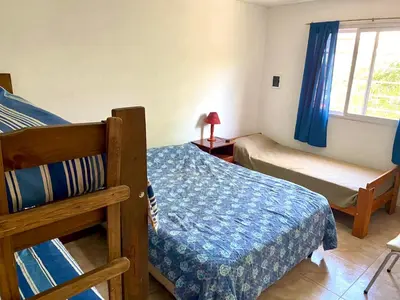 a bedroom with two bunk beds and a window at Aires de las Sierras 2 in Villa Carlos Paz