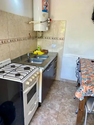 a small kitchen with a stove and a sink at Aires de las Sierras 2 in Villa Carlos Paz