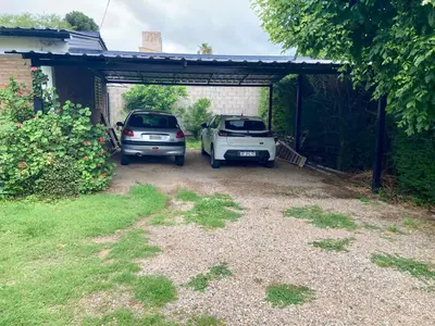two cars are parked in a garage at Aires de las Sierras 2 in Villa Carlos Paz