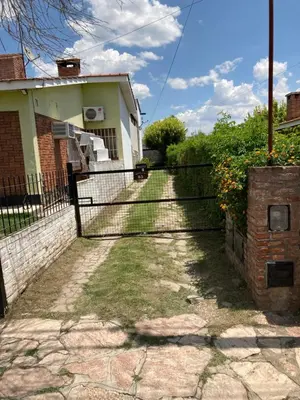 a fence in front of a house at Aires de las Sierras 2 in Villa Carlos Paz