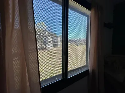 a window in a room with a view of a city at HERMOSA CASA 2 DORMITORIOS EN POTRERO DE GARAY in Potrero de Garay