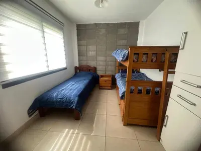 a bedroom with two bunk beds and a window at HERMOSA CASA 2 DORMITORIOS EN POTRERO DE GARAY in Potrero de Garay