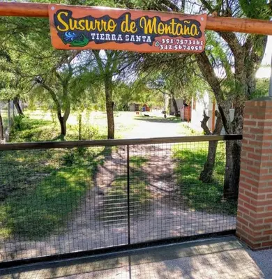 a fence with a sign for a park at Susurro de Montaña (TIERRA SANTA) in San Lorenzo