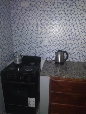 a kitchen with a stove with two tea pots on it at Susurro de Montaña (TIERRA SANTA) in San Lorenzo