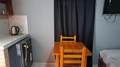 a wooden table and chair in a small room at Tierra Santa in Villa Cura Brochero