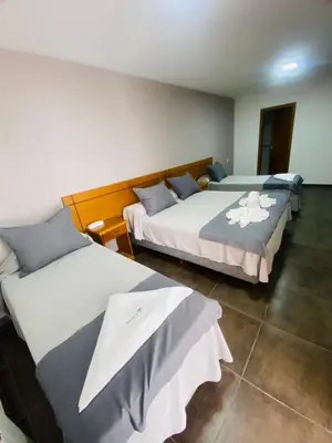 two beds in a hotel room with at Ranqueles in Villa Carlos Paz