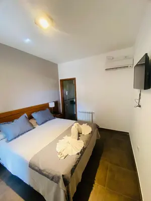 a bedroom with a bed with towels on it at Ranqueles in Villa Carlos Paz