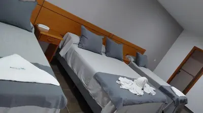 two beds in a room with towels on them at Ranqueles in Villa Carlos Paz
