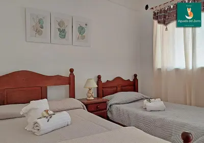 a bedroom with two beds with towels on them at Nuevo Hotel Aguada del Zorro in Merlo