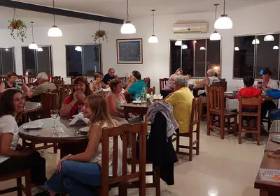 a group of people sitting at tables in a restaurant at Nuevo Hotel Aguada del Zorro in Merlo