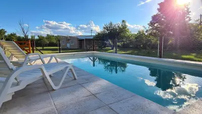a swimming pool with two chairs sitting next to it at Casa Abierta in Nono