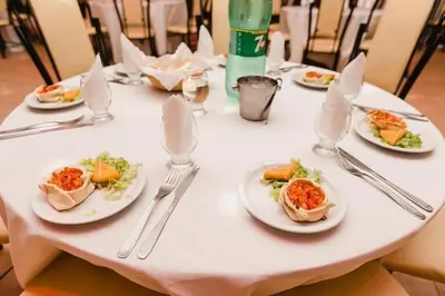 a white table with plates of food on it at Gran Turín Hotel Boutique parque,arte y tecnología in Villa Carlos Paz