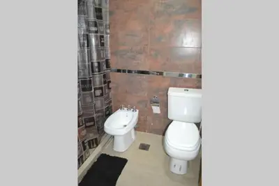 a bathroom with a toilet and a bidet at Dto con pileta en Carlos Paz 33! in Villa Carlos Paz