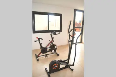 a room with two exercise bikes and a window at Dto con pileta en Carlos Paz 33! in Villa Carlos Paz