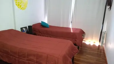 a room with two beds in a room at Dto con pileta en Carlos Paz 33! in Villa Carlos Paz