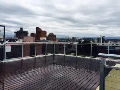 a rooftop deck with a view of a city at Ayres de Las Sierras in Villa Carlos Paz