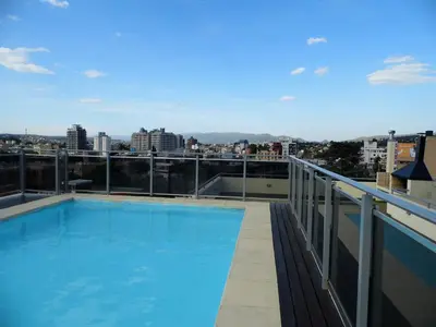 a swimming pool on the roof of a building at Ayres de Las Sierras in Villa Carlos Paz
