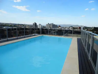 a large swimming pool on the roof of a building at Ayres de Las Sierras in Villa Carlos Paz