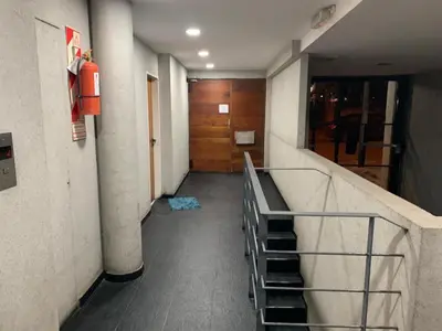 a hallway with a staircase in a building at Serena in Villa Carlos Paz