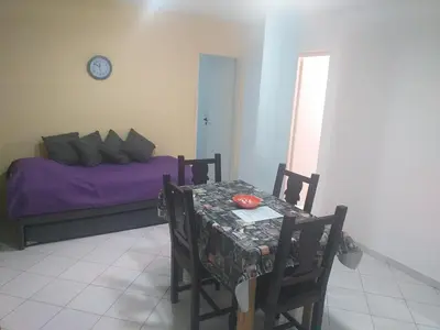 a bedroom with a table and a bed with purple sheets at Serena in Villa Carlos Paz