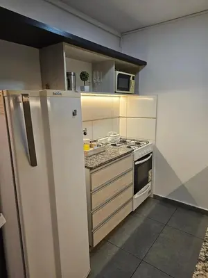 a small kitchen with a refrigerator and a microwave at LitStay Laprida 2 in Cordoba