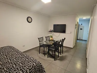 a bedroom with a table and chairs and a tv at LitStay Laprida 2 in Cordoba