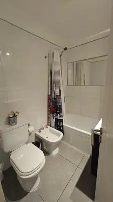 a bathroom with a toilet and a sink and a tub at LitStay Laprida 2 in Cordoba