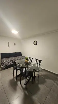 a room with a table and chairs and a bed at LitStay Laprida 2 in Cordoba