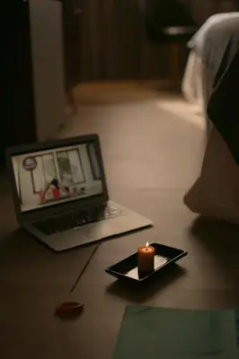 a candle on a plate with a laptop on the floor at ÑU Posta Urbana Hotel Boutique in Cordoba