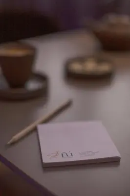 a piece of paper sitting on top of a table at ÑU Posta Urbana Hotel Boutique in Cordoba