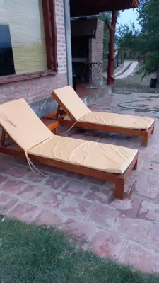 two beds are sitting on a brick patio at Cabaña Las liebres in San Roque