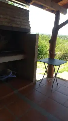 a table sitting on a patio with a tree at Cabaña Las liebres in San Roque