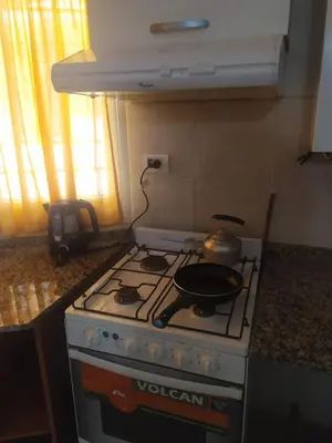 a kitchen with a stove with a pot on it at DEPARTAMENTO CARLOS PAZ in Villa Carlos Paz