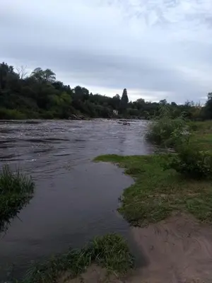 a river with some grass and trees in the background at Villa Coca -Los Jilgueros- in La Bolsa