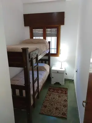 a room with two bunk beds and a window at Villa Coca-Los Agapantos- in La Bolsa