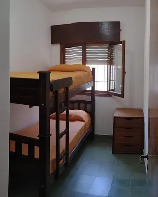 two bunk beds in a room with a window at Villa Coca-Los Agapantos- in La Bolsa